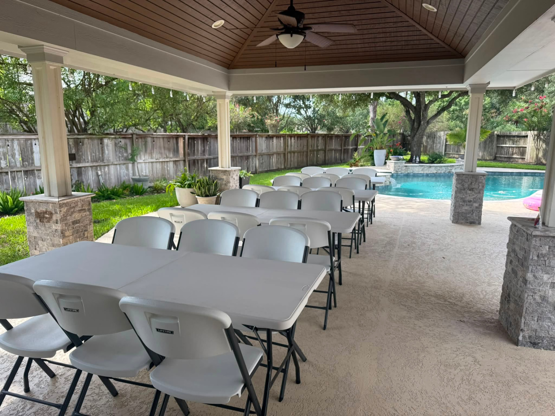 Folding table and chair rentals set up for a backyard party in North Houston, Texas